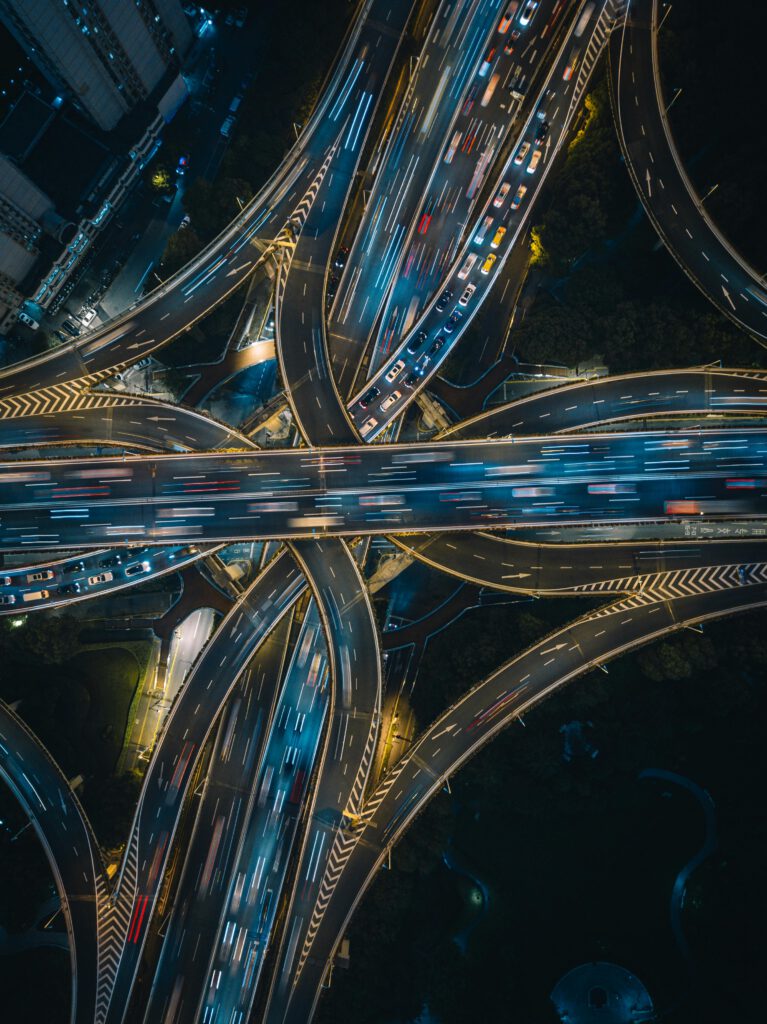 pexels-photo-7994953-7994953 Aerial view of illuminated highways in Shanghai at night, showcasing vibrant traffic flow.
